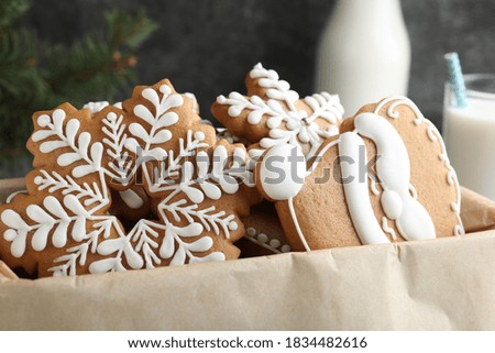 Decorated Christmas gingerbread cookies in box, closeup