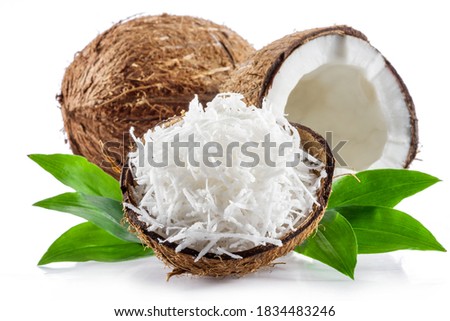 Coconut fruit and shredded coconut flakes in the piece of shell isolated on white background. Royalty-Free Stock Photo #1834483246