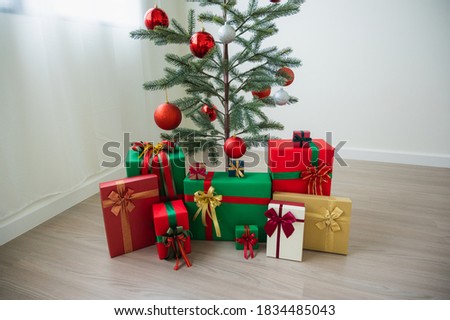 Merry christmas and happy new years. Christmas tree decorated with red and silver balls And also has gift boxes to decorate beautiful Christmas tree set in the house.