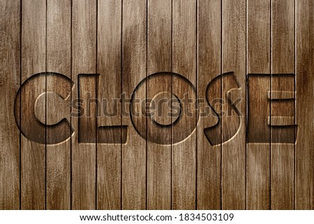 wooden wall background texture vertical pattern with carving wood text close on dark brown vintage tone color for the sign plate design of the cafe or restaurant