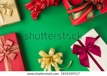 Above view gift box mockup on the green background with copy space. Merry christmas and happy new years concept.