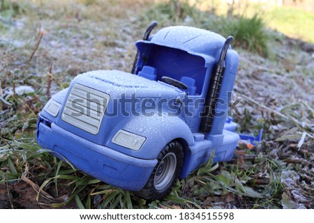 Abstract picture with a toy truck covered with frost.