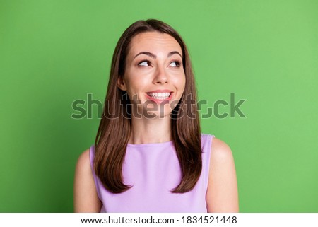 Photo of cute wondered pretty glad girlish young woman lady model look empty space advert banner interesting news sales wearing violet tank-top isolated green pastel color background