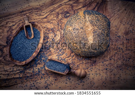 Blue poppy seeds on olive wood
