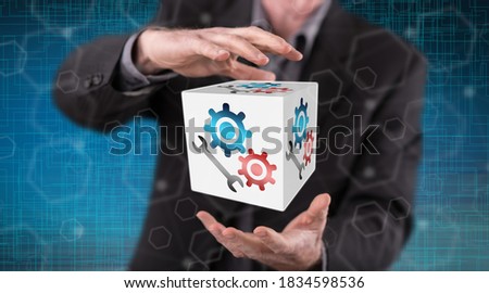 Maintenance system concept between hands of a man in background