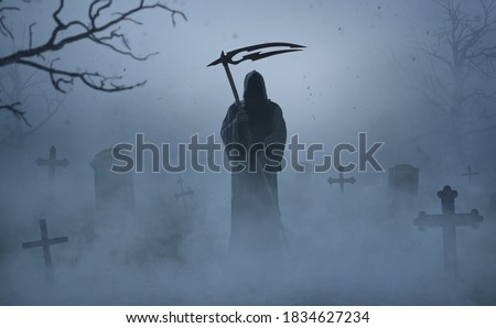 Silhouette of a grim reaper on a grave yard Royalty-Free Stock Photo #1834627234