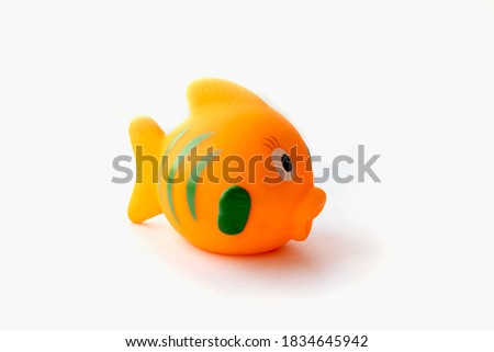 Orange rubber fish toy isolated on white background