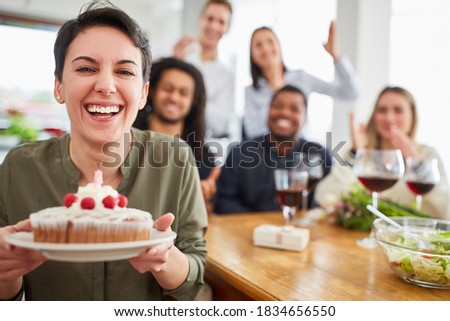 Woman cake and blown out candle at birthday party with friends at home