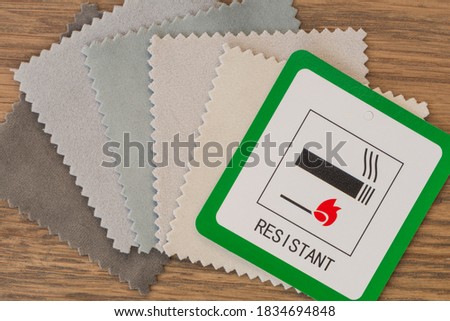 Fire resistant sign with fabric samples. Close up view from above. Royalty-Free Stock Photo #1834694848