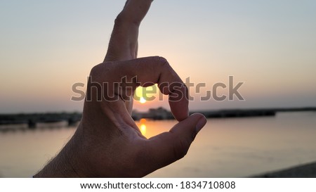 hand shape with sunset on the river