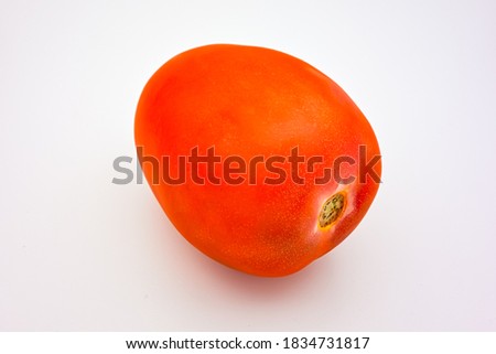 Tomato. One red tomato isolated on white background
