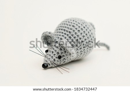 Handmade knitted toy. Mouse toy in white background . Crochet stuffed animals. 