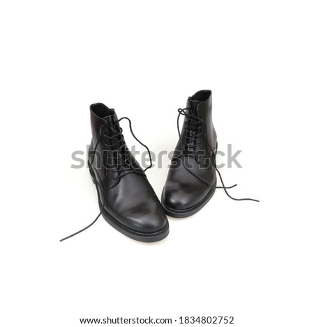 Fashionable black boots for men and women isolated on white background