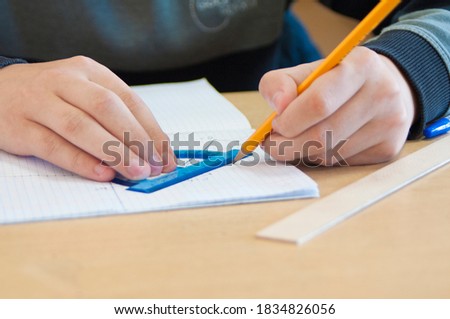 the student draws in a notebook in a cage with a pencil