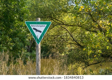 Sign "Nature reserve" on the banks of the Neckar near Freiberg am Neckar.