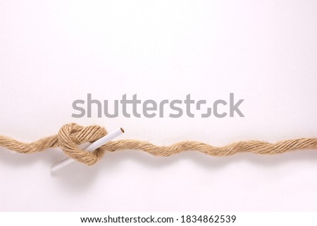 close-up of a brown strong rope, tie with smoking