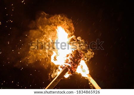 two burning torches on a dark background, smoke and fire from burning torches. Royalty-Free Stock Photo #1834865926