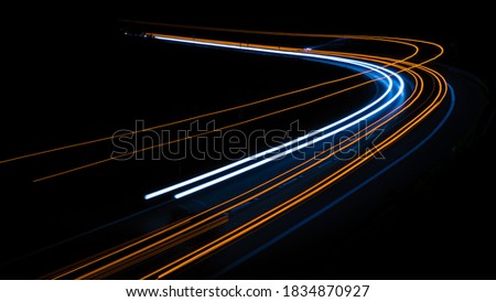orange car lights at night. long exposure Royalty-Free Stock Photo #1834870927