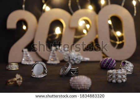 Several rings and jewelry for women on the background of the starry sky 2020