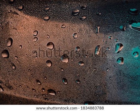 Neon condensation droplets on bottle