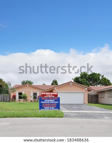 Real Estate For Sale Open House Welcome Sign Suburban Ranch Back split style home residential neighborhood USA Blue Sky Clouds