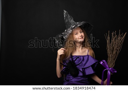Teenage girl on black background of Halloween