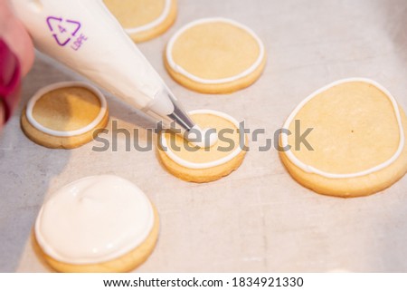 Piping Bag Decorating Royal Icing on Sugar Cookies