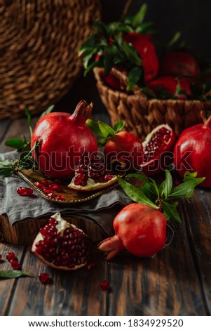 Beautiful red pomegranate fruit composition on a wooden background. Azerbaijan Royalty-Free Stock Photo #1834929520