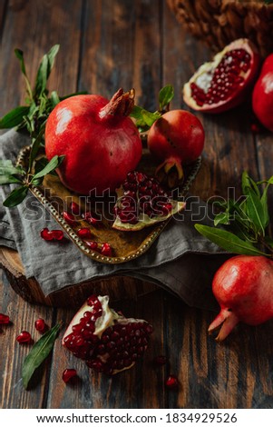 Beautiful red pomegranate fruit composition on a wooden background. Azerbaijan Royalty-Free Stock Photo #1834929526