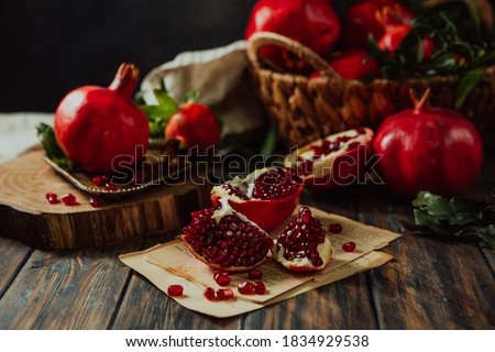 Beautiful red pomegranate fruit composition on a wooden background. Azerbaijan Royalty-Free Stock Photo #1834929538