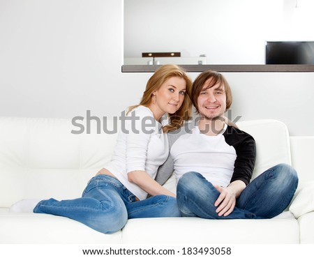 Happy couple relaxing in home
