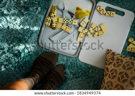 dominoes and green carpet and brown socks  Royalty-Free Stock Photo #1834949374