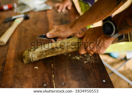 setting a fire from scratch with bamboo wood Royalty-Free Stock Photo #1834950553