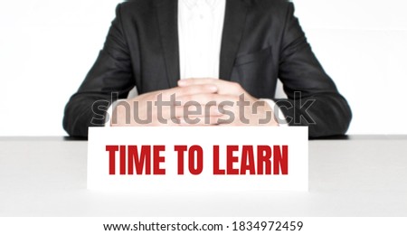 Businessman sitting at the table and signboard with text MANAGE CONFLICTS . Business concept