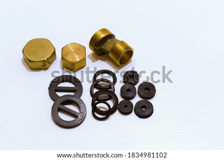 brass plugs and joints and rubber gaskets for repairing plumbing on white background Royalty-Free Stock Photo #1834981102