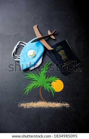 Indians Travelling during corona virus epidemic. Indian Passport and protective face mask respirator. Coronavirus and travel or tourism concept. Travelling to the beach