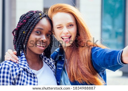 Happy brightful positive moments of two stylish girls