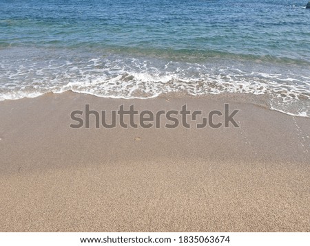 gravel and sand with calm waves