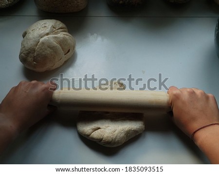 Hands of a woman with a bread dough