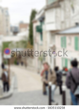 Defocused photography. Sunny spring day in Paris. Typical street in Montmartre Architecture of France. Blurred background with copy space for your design.
