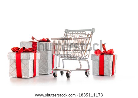 Products cart. Trolley cart for supermarket with christmas or birthday gift box isolated on white background. Minimalism style. Creative design for valentine, xmas surprise package.