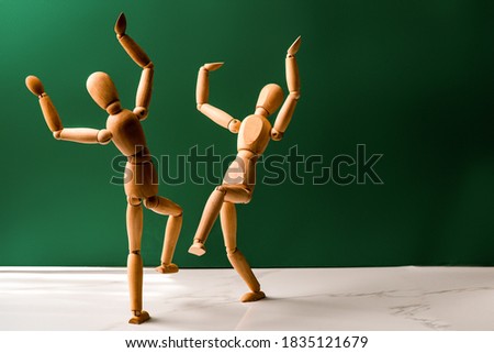 The concept of celebrating the Jewish holiday Simchat Torah. Two wooden men are dancing
