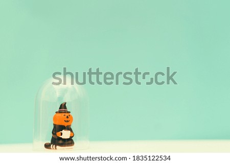 jack o lantern holding coffee cup stay home on green background.Stay home stay safe lockdown at home.Relax in holidays halloween party online.Protection from coronavirus covid19 pandemic.Pumpkin witch
