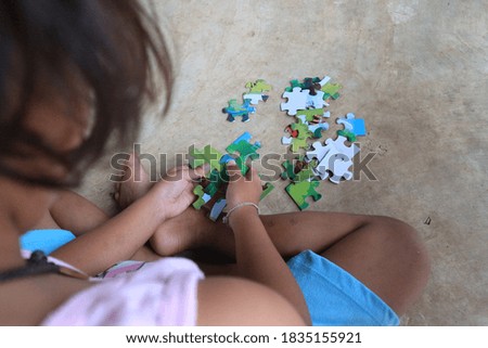 young girls playing puzzles at home.Stay at home.Education.