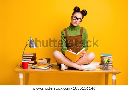 Full length photo of minded pensive girl sit table legs crossed write copybook, look copyspace think thoughts wear green pullover dress skirt overall isolated bright shine color background