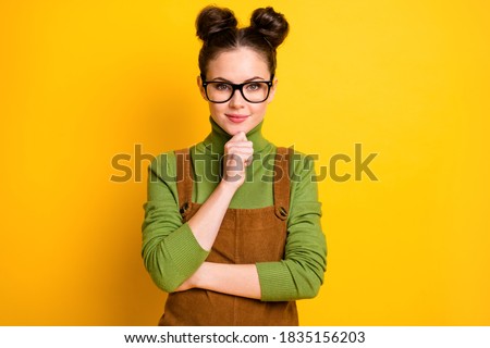 Photo of charming minded curious girl touch fingers chin ready plan think thoughts, wear sweater overall isolated over bright color background