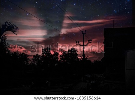 stary sky with dramatic clouds after sun set silhouette dark background photo blury faded