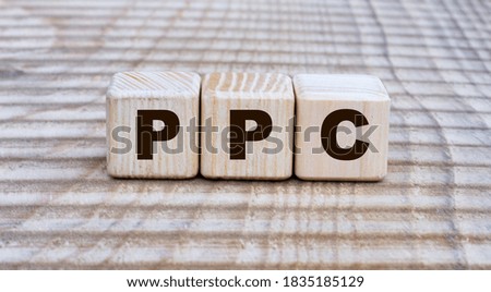 concept of the word PPC (Pay Per Click) on cubes on a beautiful background. Business concept