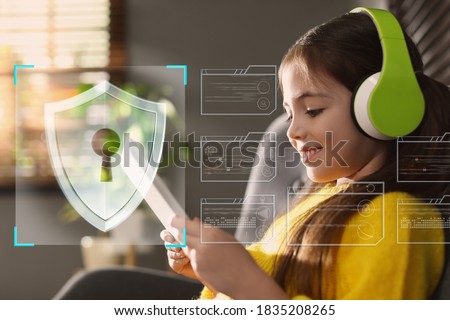 Child safety online. Little girl using tablet at home. Illustration of internet blocking app on foreground Royalty-Free Stock Photo #1835208265