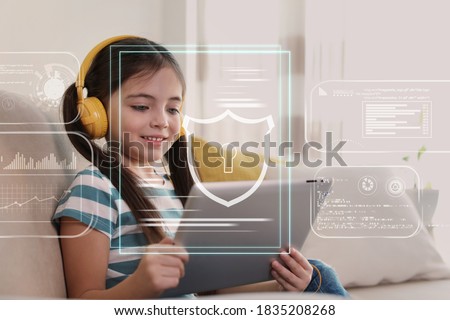 Child safety online. Little girl using tablet at home. Illustration of internet blocking app on foreground Royalty-Free Stock Photo #1835208268